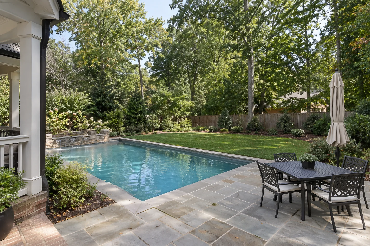 Pool, patio dining area, and backyard lawn
