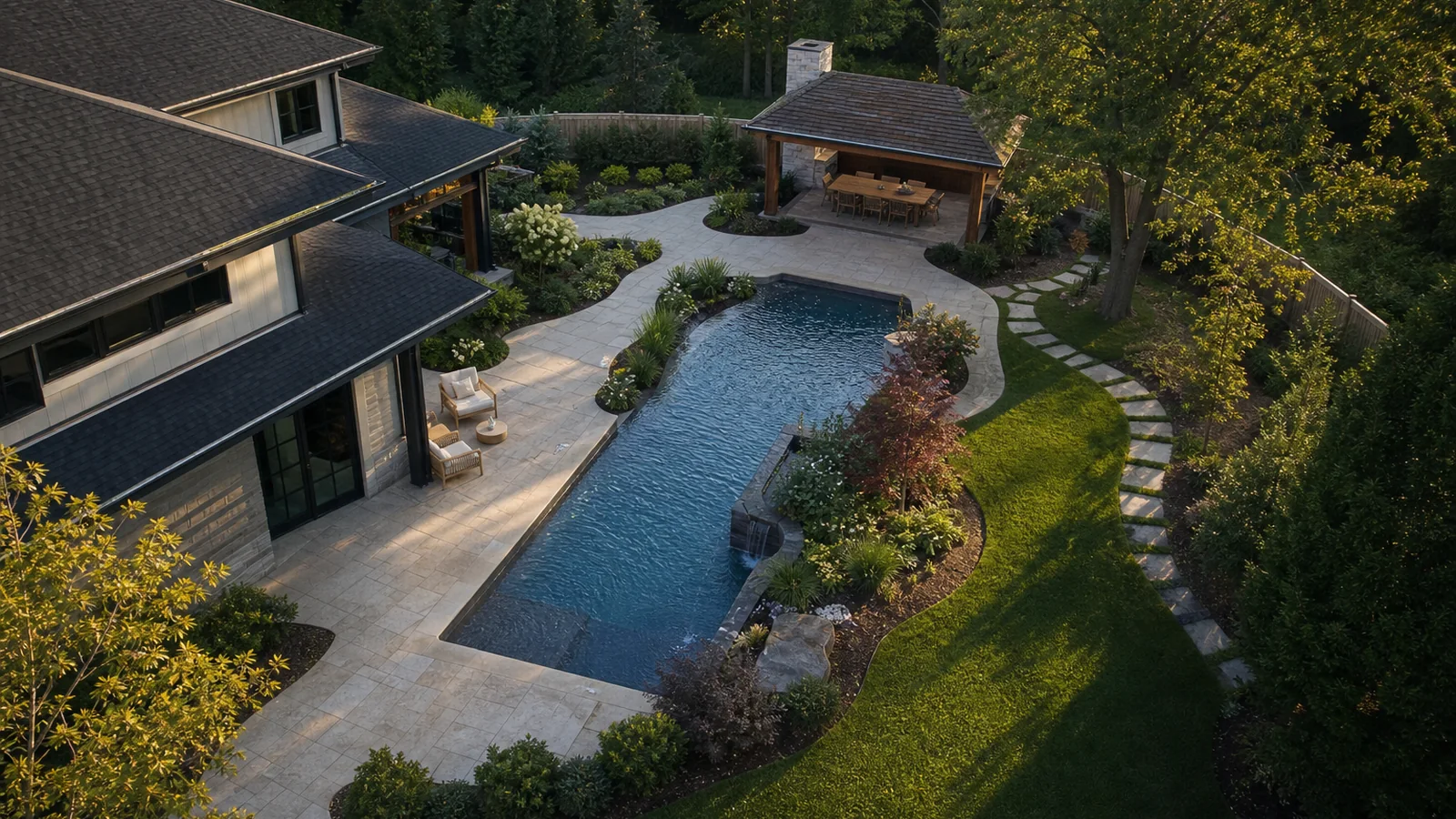 Aerial view of a pool, terraces and surrounding backyard
